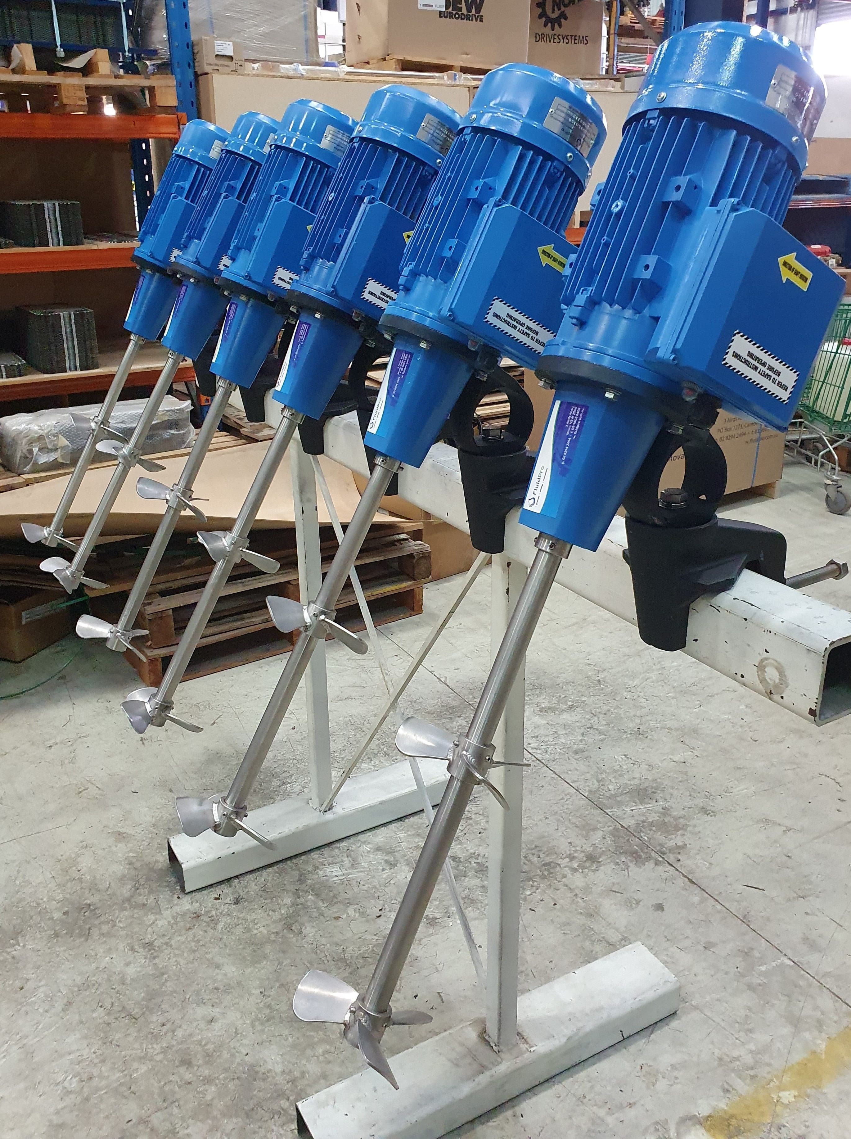 A row of six FluidPro Clamp Mount Mixers attached to a post.