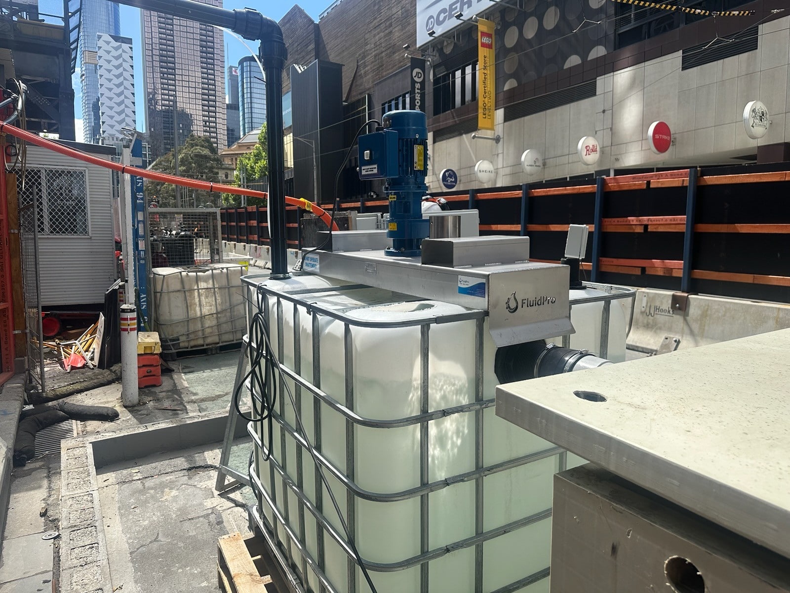 FluidPro bridge mount IBC tote tank agitator being used in a chemical dosing water treatment project. 
