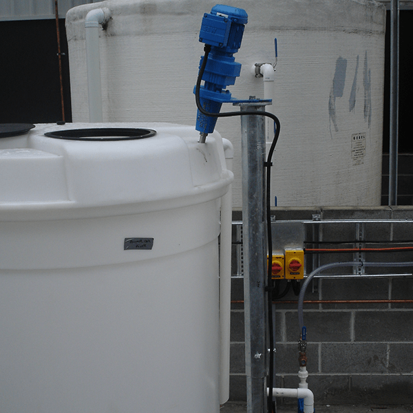 An IBC mixer with stainless steel bridge and VSD mounted to a white plastic IBC mixer with steel supports. 