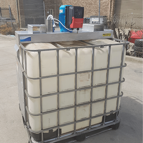 An IBC mixer with stainless steel bridge and VSD mounted to a white plastic IBC mixer with steel supports. 
